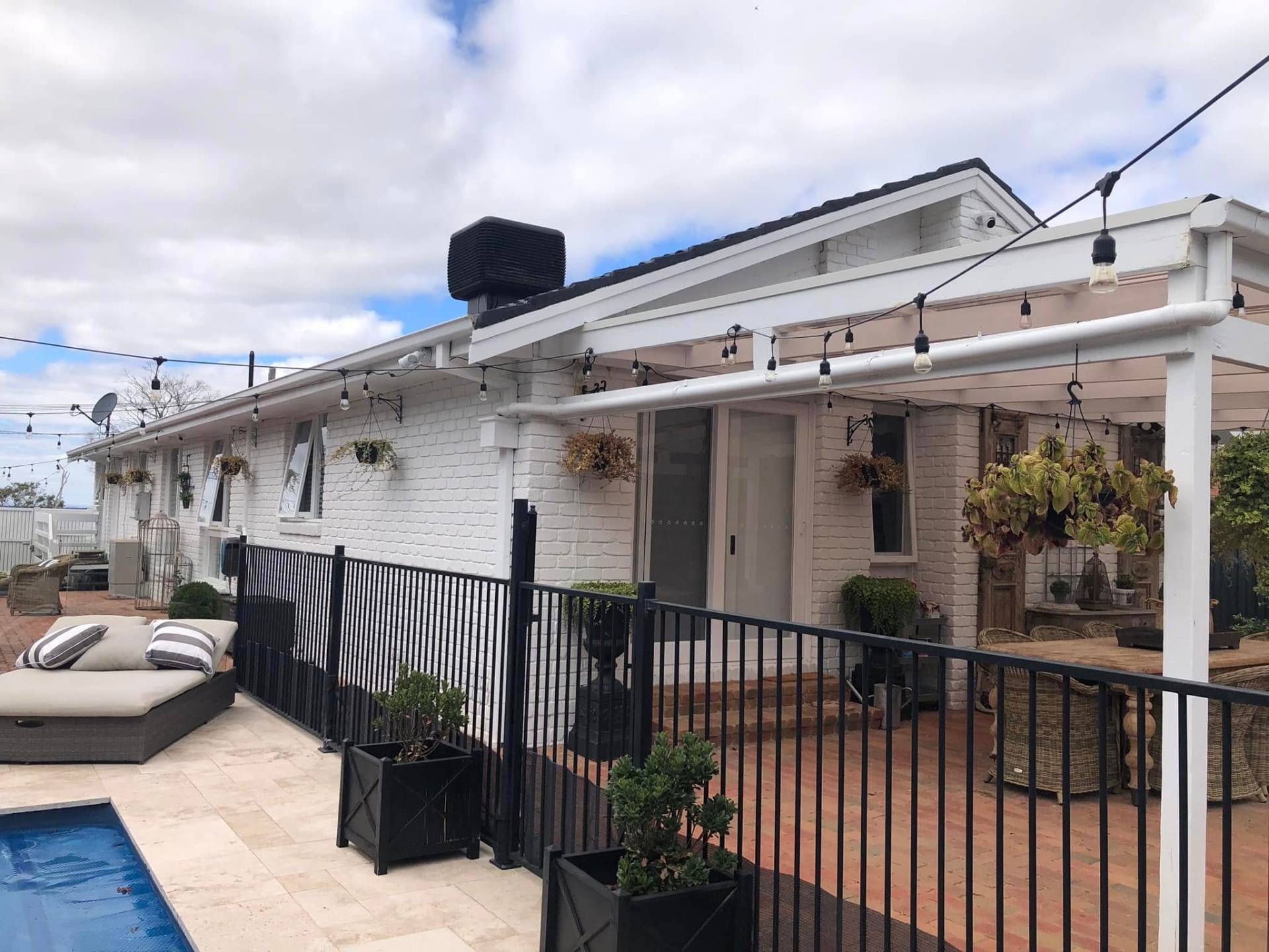Crisp white brick coastal home repainted by AquaZen